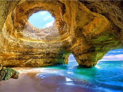 Stunning Benagil Cave with golden rock formations and turquoise waters in the Algarve, Albufeira Portugal